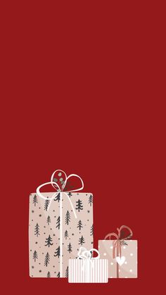 two presents are sitting next to each other on a red background with the words merry christmas