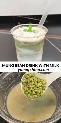 a cup filled with milk and green beans next to a spoon full of liquid on top of