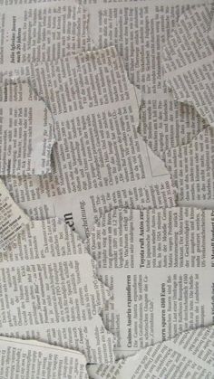 many pieces of newspaper are scattered on top of each other