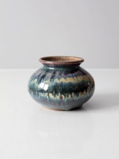 a small vase sitting on top of a white table