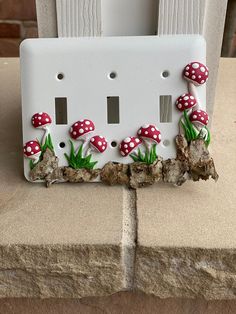 a light switch cover with mushrooms on it