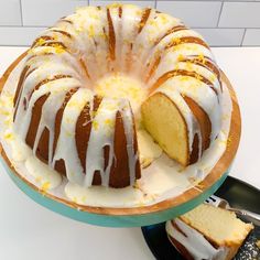 a bundt cake with white icing and lemon drizzle