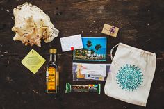 an assortment of items on a wooden table including a bottle, soap, and other things