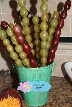 grapes are arranged in a bucket on the counter