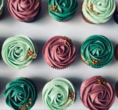 several cupcakes with different colored frosting on them