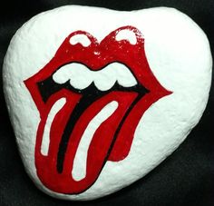 a painted rock with the rolling stones logo on it