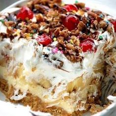 a close up of a cake on a plate with fruit and nuts in the middle