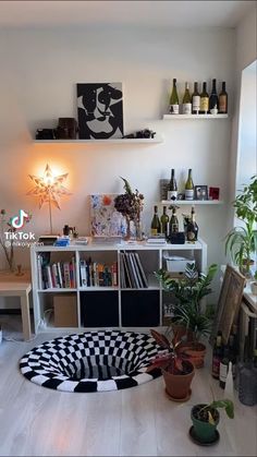 a living room filled with furniture and lots of bottles on top of the shelfs