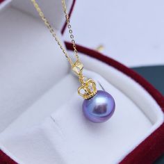 Step out in style with a breathtaking freshwater pendant necklace from House of Pearls. This stunning necklace features genuine 4A white or purple freshwater pearls — 11-12mm in size — with a gorgeous crown pendant at the center. It’s a timeless addition to any jewelry collection that’s sure to make a statement. Enjoy the luxury of wearing something delicate and regal, and make each day a little brighter. 11-12mm Freshwater Pearl Necklace This popular necklace design features AAAA quality, round Elegant Purple Pearl Pendant Necklace, Elegant Purple Round Pearl Necklace, Crown Pendant Necklace, Pearl Crown, Popular Necklaces, Crown Pendant, Perfect Circle, Pearl Jewelry Necklace, Purple Pearl