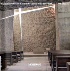 the inside of a church with pews in front of it and a cross on the wall