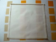 an empty piece of paper sitting on top of a checkered tablecloth covered in yellow and white squares