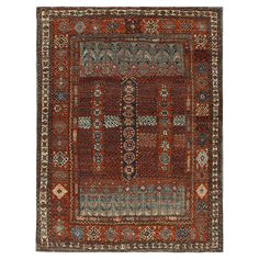 an antique persian rug with various colors and designs on the border, in red tones