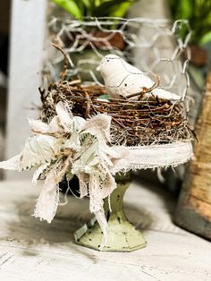 a bird nest with two white birds in it