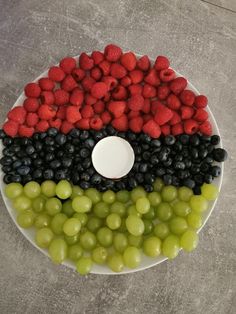 grapes and raspberries arranged in the shape of an egyptian flag on a plate