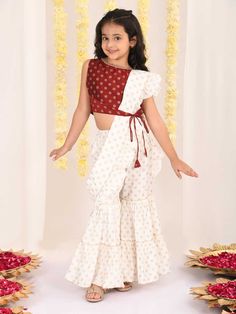 VASTRAMAY Girl's Maroon And Cream Palazzo Saree Set Let your little one shine in style with this adorable set featuring a trendy maroon crop top and a flowy cream palazzo with an attached dupatta. This viscose set is perfect for parties and special occasions, and is easy to care for with dry cleaning. Key Features Maroon printed crop top with round neck and border Cream colored palazzo with foil print and elasticated waistband Attached ruffle dupatta with a bow hair clip Specifications Sleeve Le Traditional Cream Palazzo Set With Dupatta, Navratri Semi-stitched Palazzo Set With Pallu, Traditional Red Floor-length Palazzo Set, Navratri Cream Semi-stitched Palazzo Set, Maxi Length Semi-stitched Palazzo Set With Pallu, Maroon Crop Top, Ruffle Dupatta, Print Crop Tops, Top Fabric