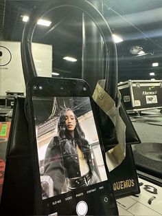 a cell phone sitting on top of a table next to a black bag and other items