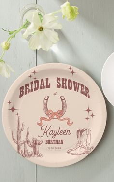 a paper plate with the words bridal shower written on it next to a flower