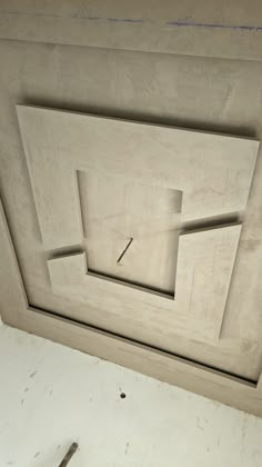 an unfinished wall with a clock on it