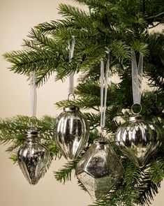 silver ornaments hanging from a christmas tree