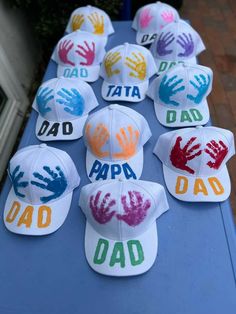 hats with hand prints on them sitting on a table