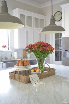 an image of a kitchen with flowers in the center and other items on the counter