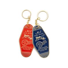 two key chains with different colored luggage tags on them, one is red and the other is blue