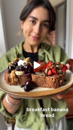 a woman is holding a plate with food on it and the words breakfast banana bread