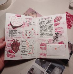 someone is holding an open valentine's day scrapbook with pictures and hearts on it