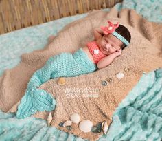 a baby is laying on a blanket and smiling