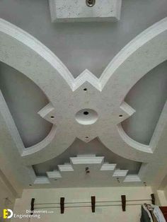 the ceiling is painted white and has decorative designs on it