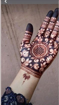 a woman's hand with henna on it