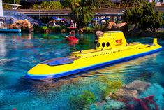 a yellow submarine floating on top of blue water