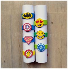 two rolls of white paper with different colored emoticions on them, one rolled up and the other rolled down