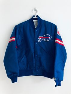 a buffalo jacket hanging on a hanger with the buffalo logo and red, white, and blue stripes