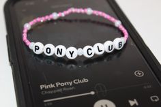 Infuse your style with the spirit of 'Pink Pony Club' through this handcrafted beaded bracelet. Each bead is a burst of vibrant color and lively pattern, creating a stylish accessory that effortlessly embodies the song's upbeat energy. Customized Pink Stretch Bracelet With Round Beads, Customized Pink Bracelet Wristband, Customized Pink Trendy Beaded Bracelets, Casual Customized Pink Friendship Bracelets, Casual Handmade Pink Name Bracelet, Pony Club, Rose Bracelet, Stylish Accessories, Arm Band