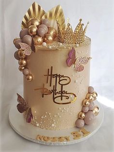 a birthday cake decorated with gold and pink decorations