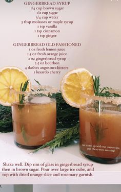 two glasses filled with drinks sitting on top of a table next to lemons and rosemary