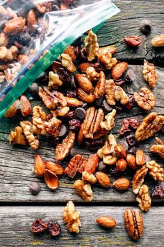 nuts and raisins are scattered on an old wooden table with a plastic bag