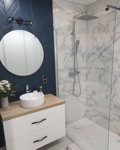 a white sink sitting next to a walk in shower