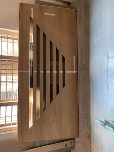 an unfinished wooden door in the corner of a room that is being renovated with metal bars