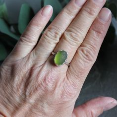 Do you need a gift for someone who is hard to buy for? Do you need jewelry for a tropical vacation or beach wedding? Sea glass jewelry is always a great for gift giving! Here are the details:This ring has a chunky piece of olive green sea glass that is set in a fine and sterling silver scalloped bezel and soldered to a sturdy silver band. Size 7 3/4. All of our sea glass is found and never altered in any way. This item was handmade by Barb Macy in Corvallis, OR. Gold Sea Glass Ring, Handmade Sea Glass Ring Jewelry, Elegant Green Sea Glass Jewelry, Handmade Adjustable Sea Glass Rings, Plain Silver Rings, Hand-wrapped Sea Glass Jewelry For The Beach, Sea Glass Ring, Sea Glass Bracelet, Sea Glass Earrings