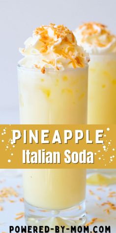 two glasses filled with pineapple italian soda sitting on top of a white tablecloth