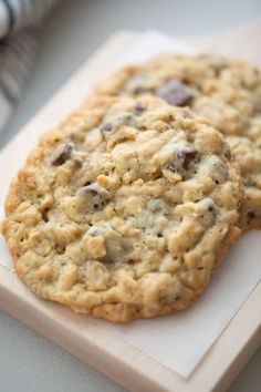 two cookies sitting on top of a cutting board