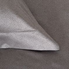 a close up view of a gray fabric with white dots on the back and side