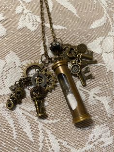 Antique Bronze Necklace includes hourglass , Gears, Keys, Made With Love and More. Chain Length:  28.5"  Lobster Claw Clasp. Center Drop:  3" Antique Key Necklace, Hourglass Pendant, Antique Keys, Hour Glass, Bronze Necklace, Steampunk Style, Bronze Pendant, Key Necklace, Steampunk Fashion