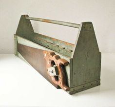 an old wooden tool box sitting on top of a white table