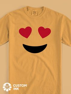 a yellow t - shirt with red hearts on it