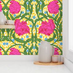 the wallpaper is bright and colorful with pink flowers on yellow, blue, and green leaves