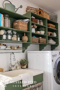 a washer and dryer in a small room with shelves above the washing machine