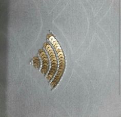 three gold and silver feathers on a gray background with white circles in the middle, as well as two smaller ones